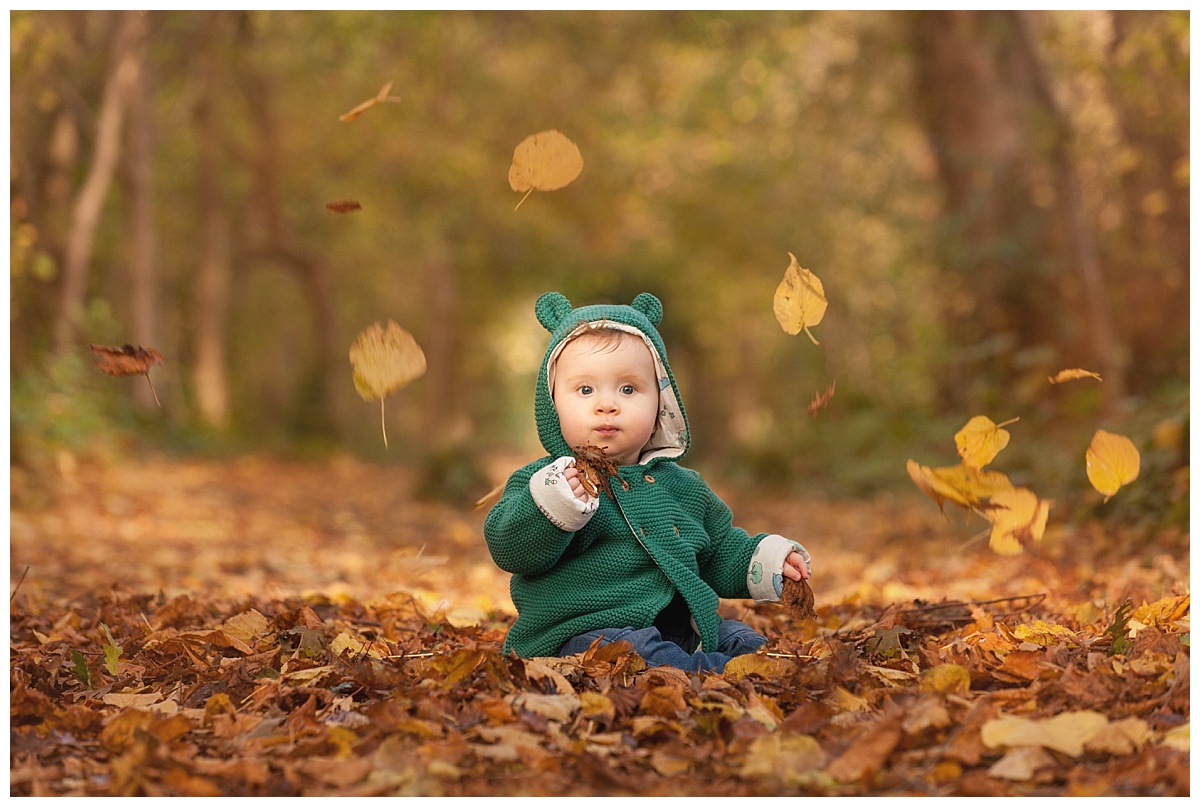 family photography by edinburgh family photographer beautiful bairns photo of boy sitting in autumn leaves at lauriston castle