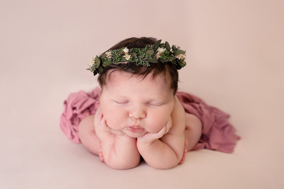 professional newborn portrait of baby girl in froggy pose with green floral headband by edinburgh newborn photographer Beautiful Bairns Photography