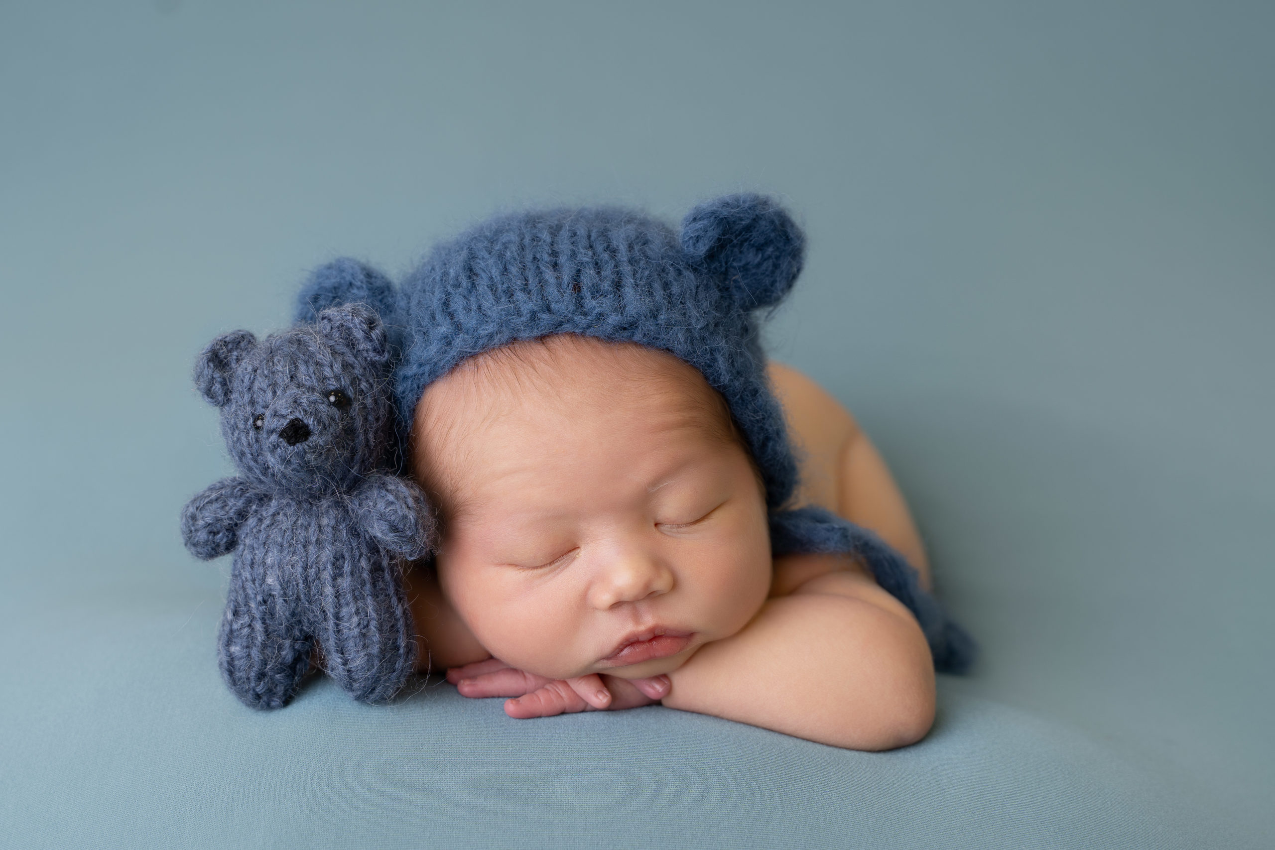 professional newborn photo of newborn baby posed on teal blanket by newborn photographer edinburgh beautiful bairns