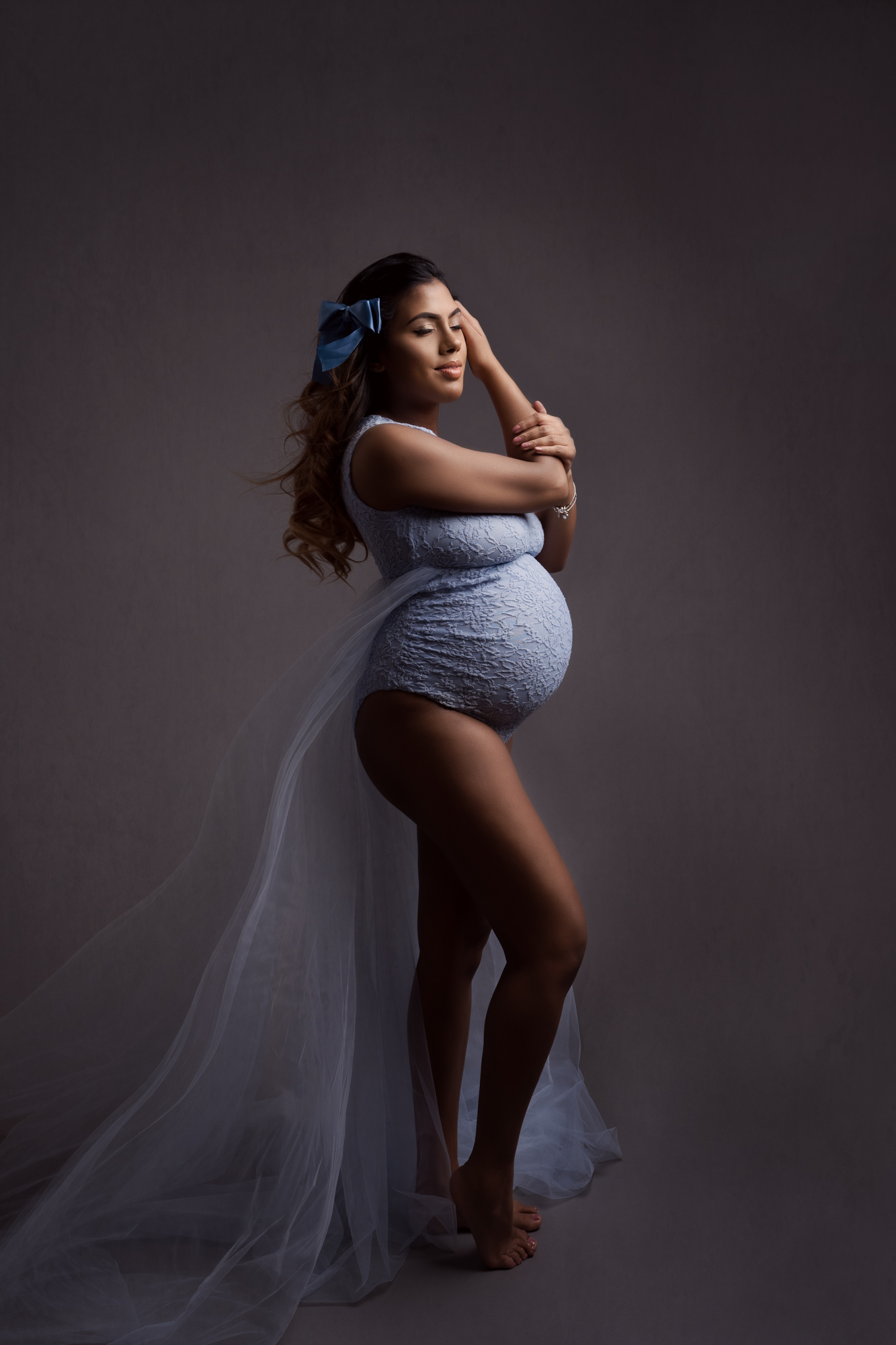 professional maternity photo of pregnant woman wearing a blue lace bodysuit with tulle train taken by maternity photographer Beautiful Bairns Photography Edinburgh