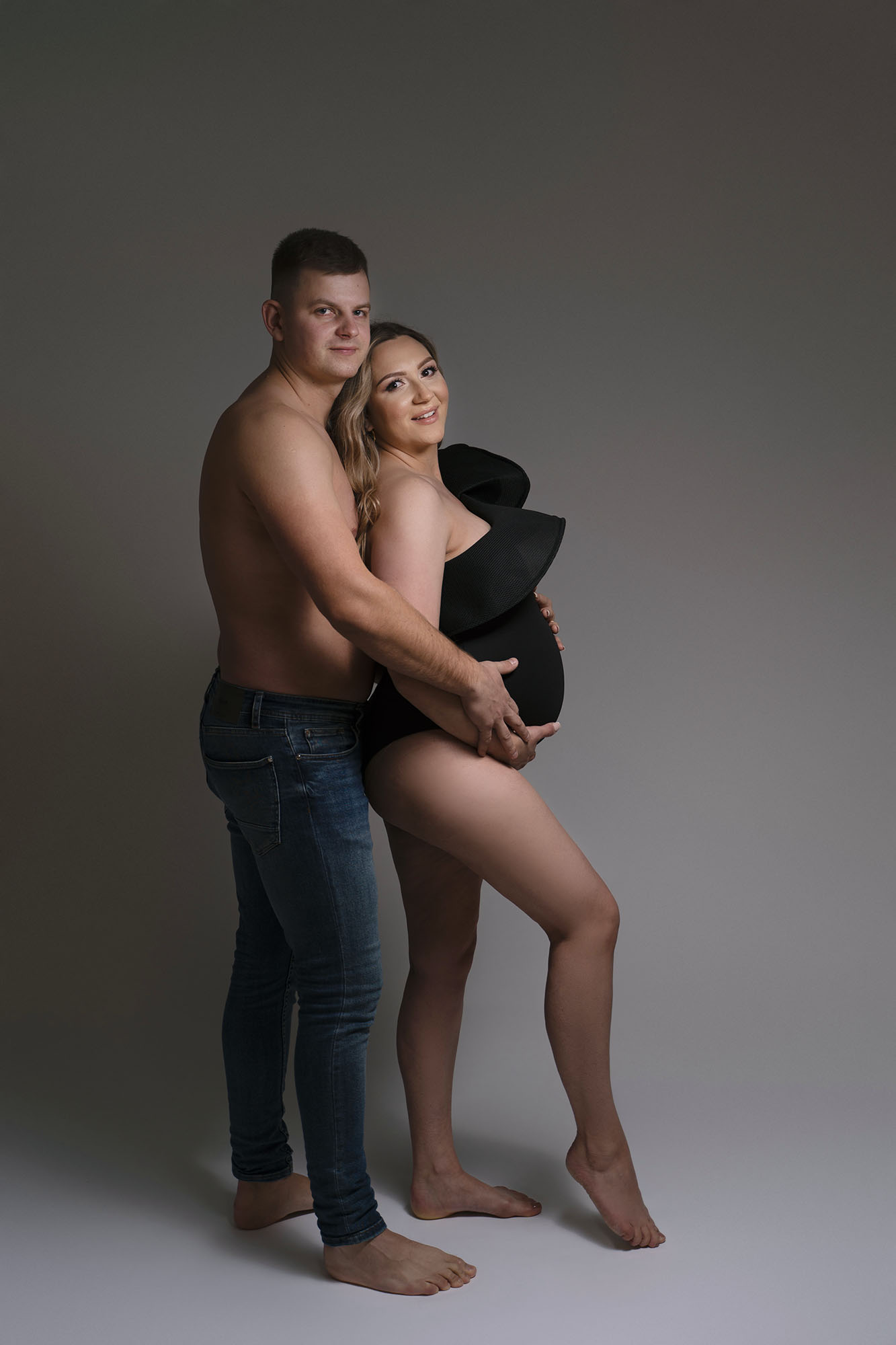 maternity photography showing Edinburgh couple posing together showing off baby bump by Beautiful Bairns Photography Edinburgh