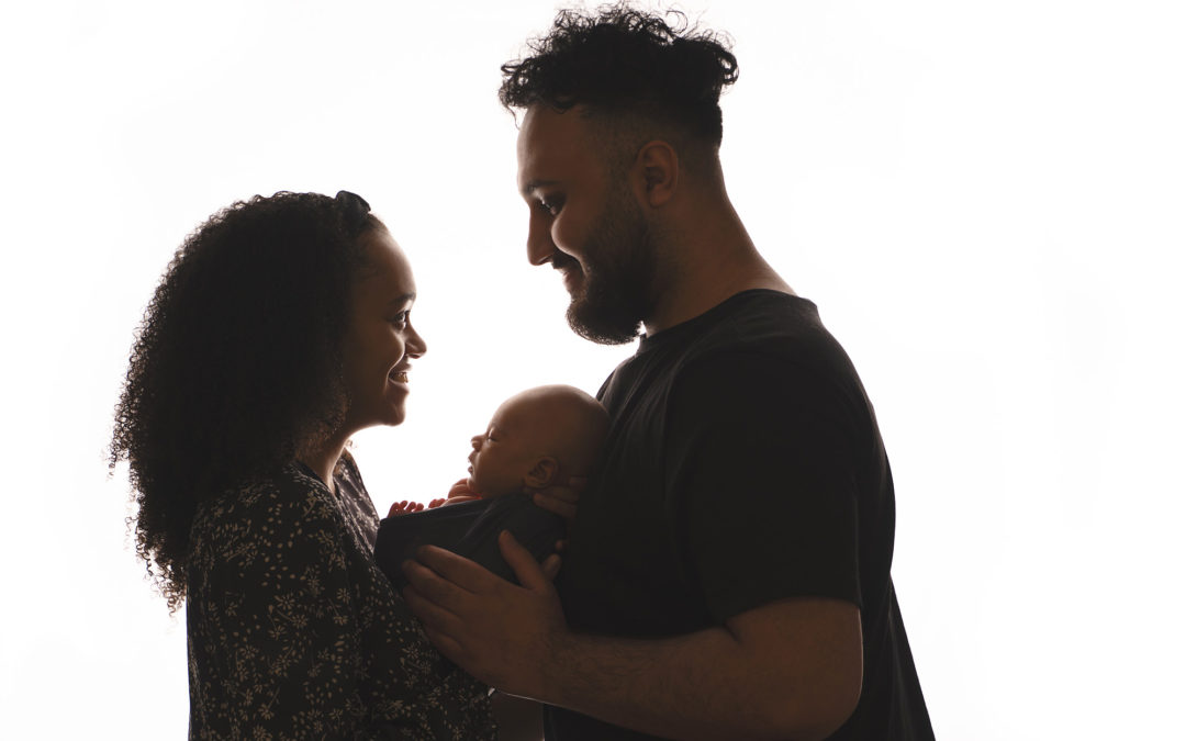 backlit portrait of new parents holding their newborn baby by Beautiful Bairns photography edinburgh