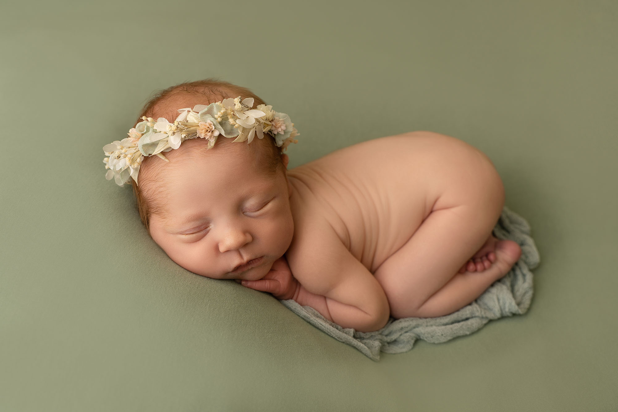 baby girl beautifully posed asleep in newborn photoshoot in Edinburgh