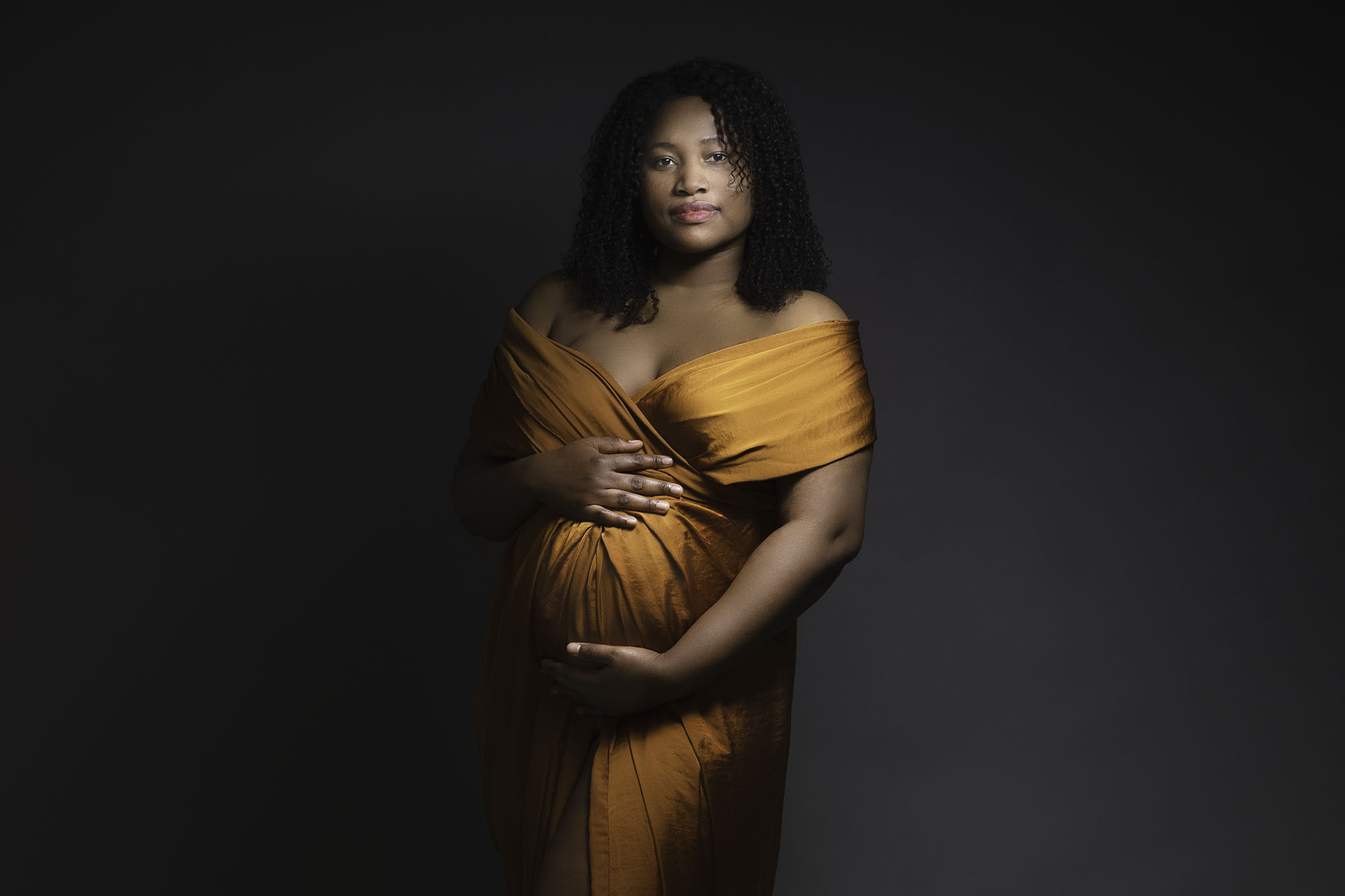 maternity photographer edinburgh portrait of pregnant woman with bronze silk fabric