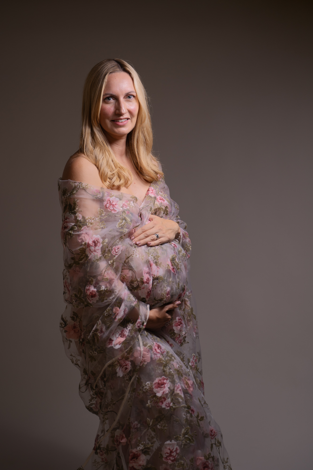 maternity photoshoot image of pregnant woman with floral fabric over her bump by edinburgh maternity photographer beautiful bairns photography