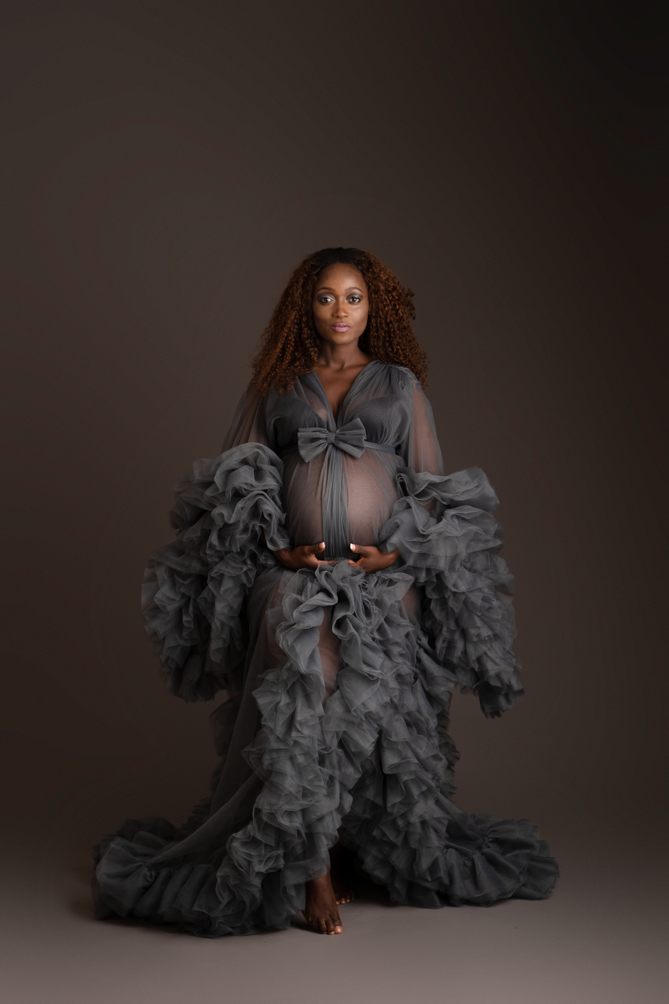 maternity photoshoot image of pregnant woman wearing a dramatic grey frilly maternity gown by edinburgh maternity photographer beautiful bairns photography