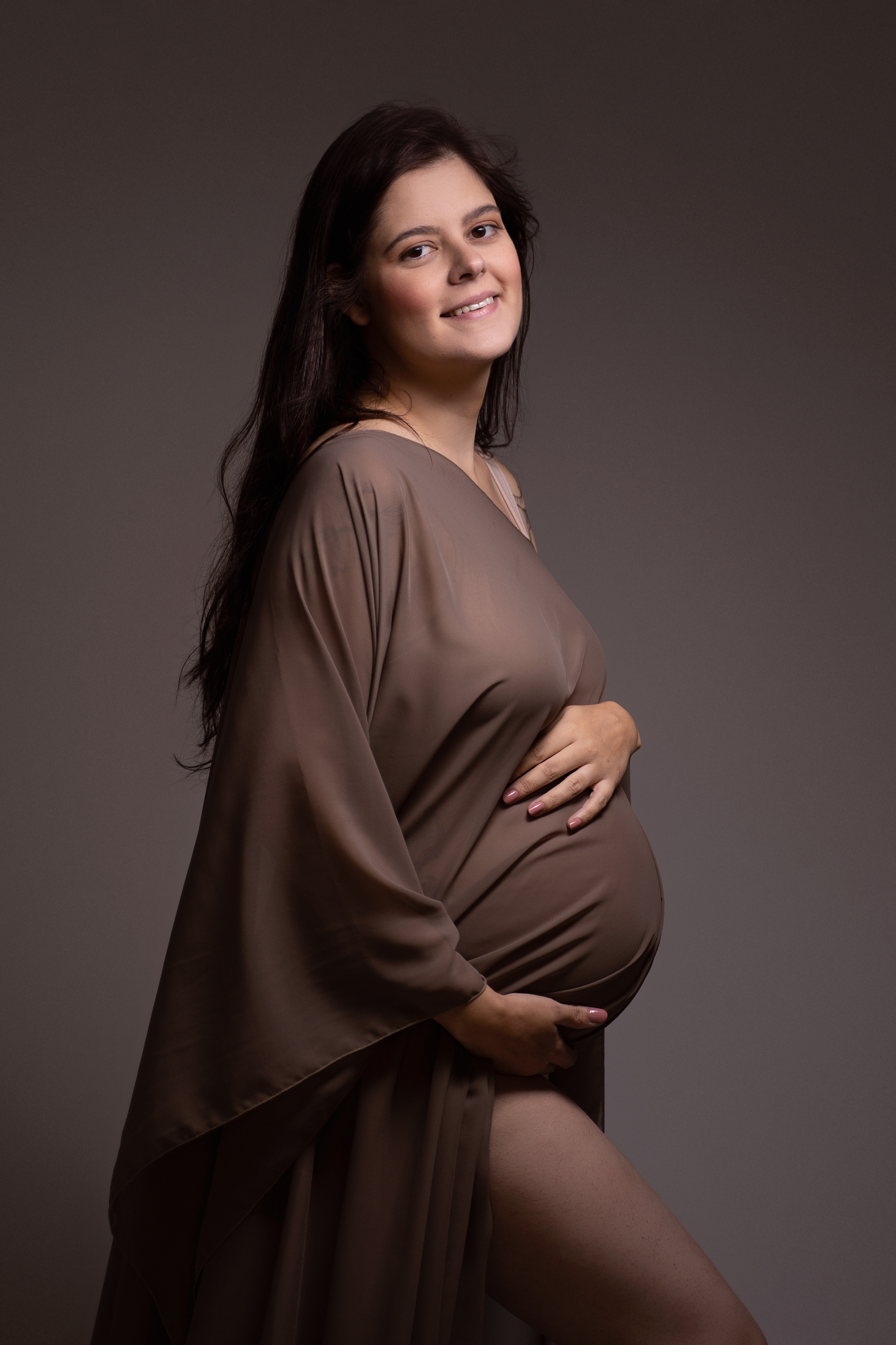 maternity photoshoot image of pregnant woman with brown chiffon cape over her bump by edinburgh maternity photographer beautiful bairns photography